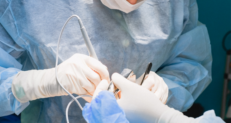 A veterinarian operating on a dog to perform gastropexy surgery and prevent canine GDV